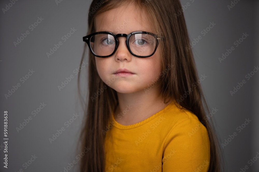 Adorable six years old girl isolated on white studio background, pretty brown-haired fringe hairstyle european appearance child pose indoor, look at camera Adorable six years old girl isolated on white studio background, pretty brown-haired fringe hairstyle european appearance child pose indoor, look at camera