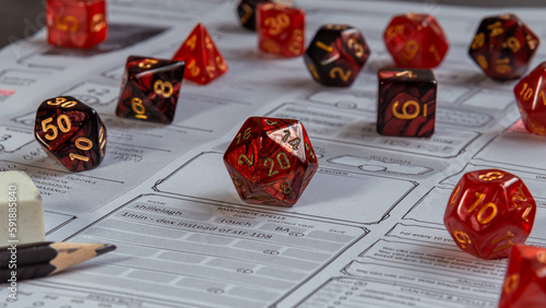 A set of Red RPG gaming dice on a character sheet