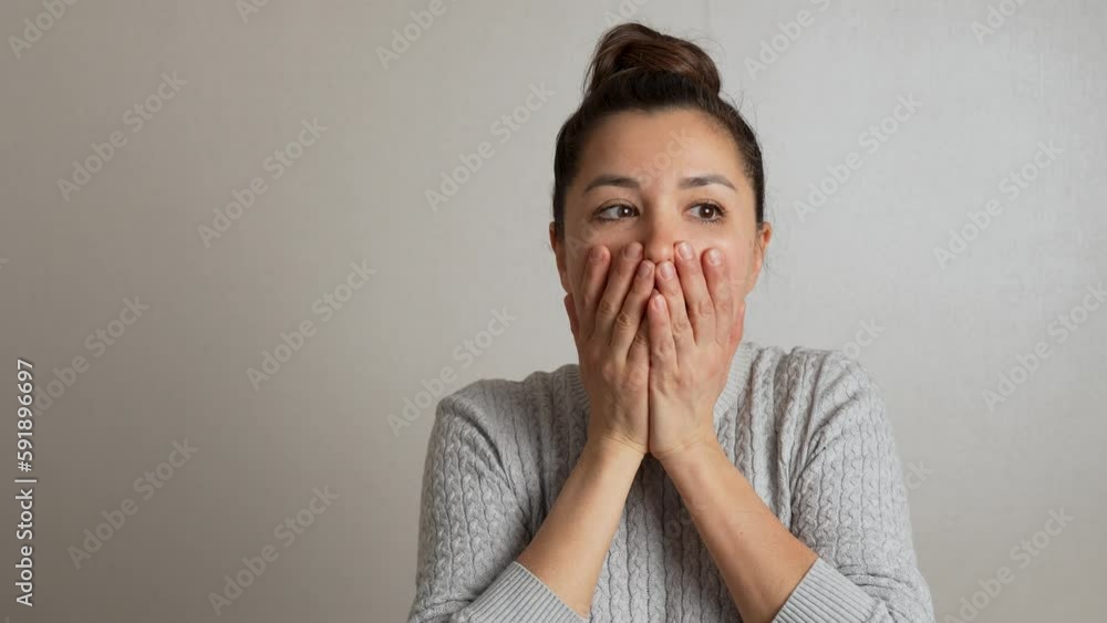 Portrait of shocked woman touching face, close-up Portrait of shocked woman touching face, close-up