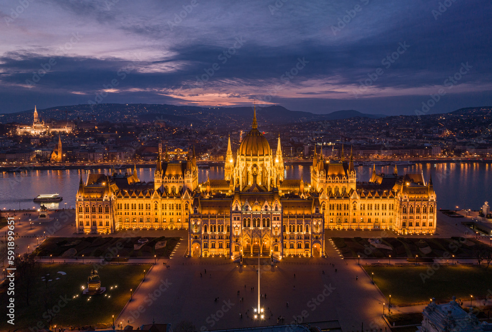 Hungarian Parliament Building in Budapest Cityscape A Bird's Eye View from a Drone Point of View over the Danube River. Night