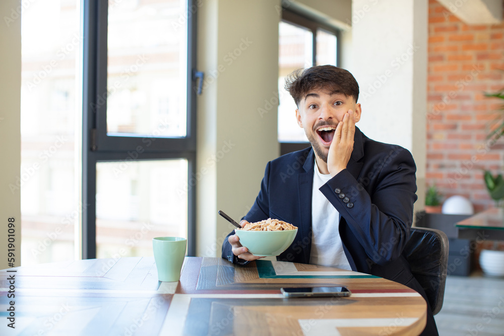 young handsome man feeling happy and astonished at something unbelievable. breakfast concept young handsome man feeling happy and astonished at something unbelievable. breakfast concept