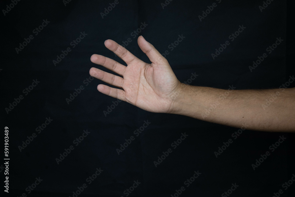 Fototapeta premium hand of a scared man asking for urgent help on black background_