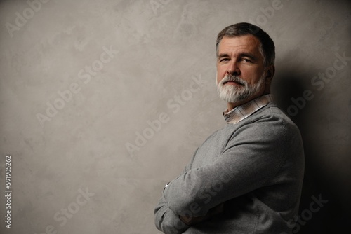 Fototapeta Naklejka Na Ścianę i Meble -  Portrait of happy casual mature man smiling, senior age man with gray hair, Isolated on dark gray background
