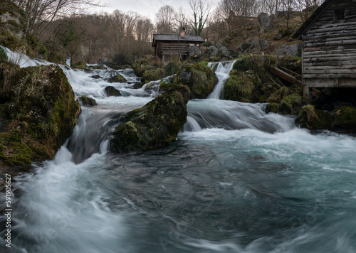 Mountain river with mossy rocks and wooden watermills, river Krupa in Krupa na Vrbasu photo