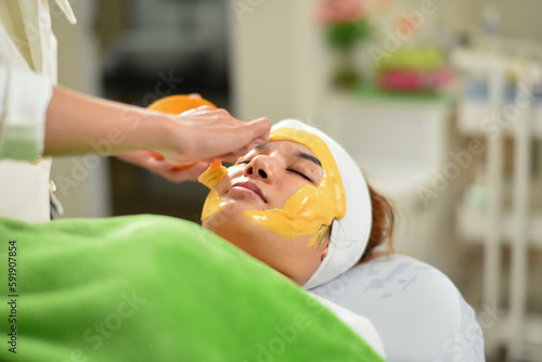 The woman has a facial treatment , face massage