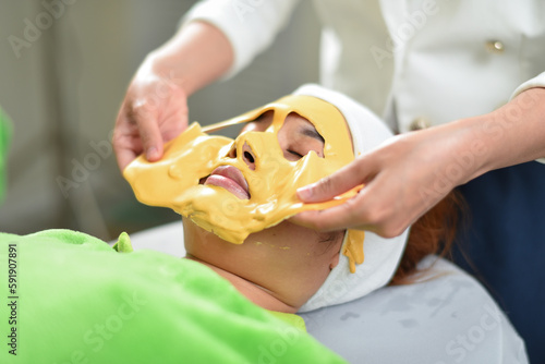 The woman has a facial treatment , face massage