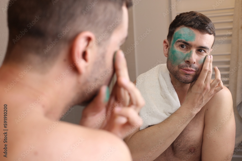 Man using a green beauty face mask Man using a green beauty face mask