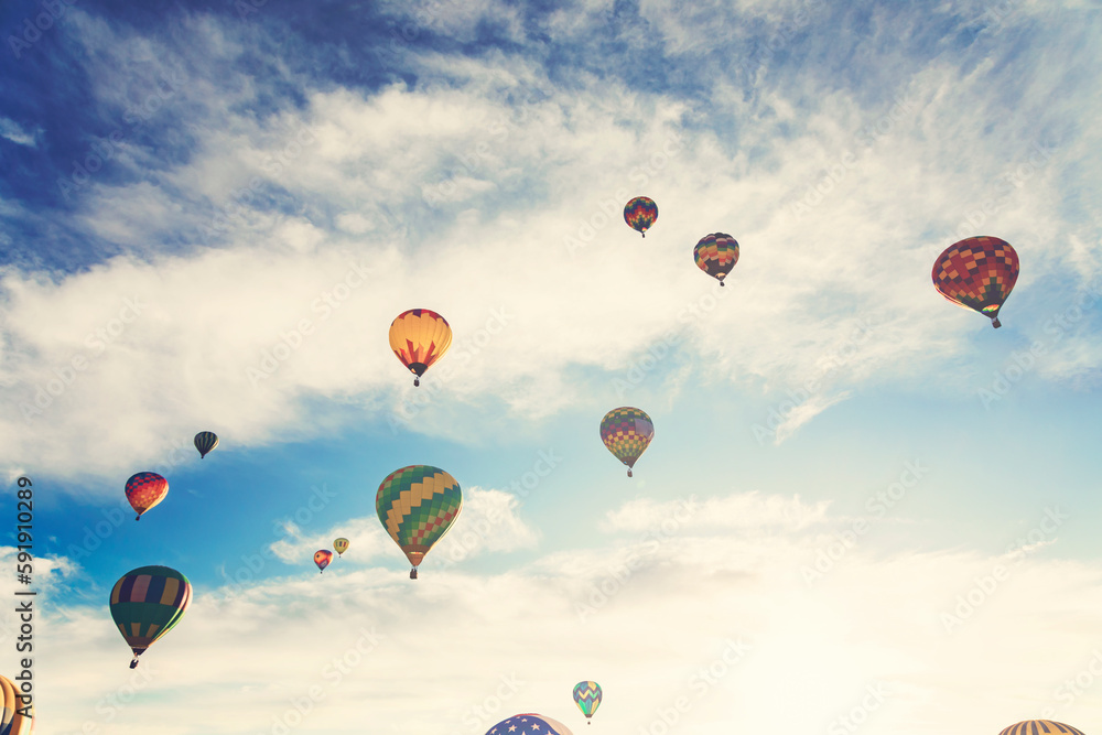 Hot air balloons flying over sunny sky