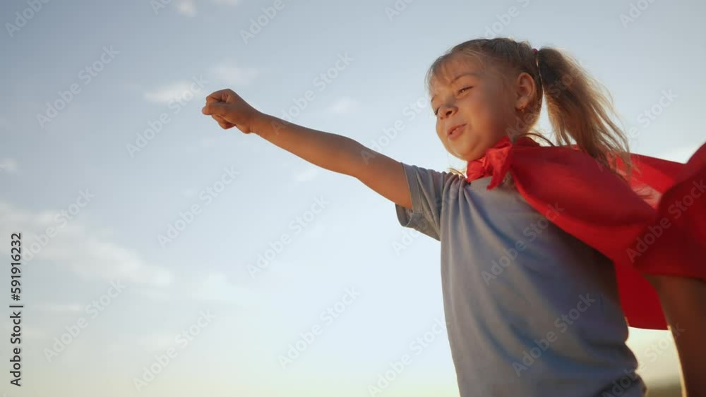 kid superhero. girl daughter happy family a dream concept. baby girl superhero close-up in red cape at sunset. portrait child superhero close-up. strength fantasy lifestyle concept kid superhero. girl daughter happy family a dream concept. baby girl superhero close-up in red cape at sunset. portrait child superhero close-up. strength fantasy lifestyle concept