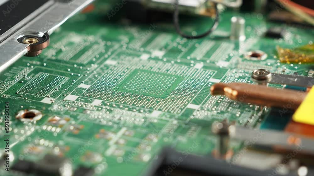 Electronic board of an old broken laptop. Rotating Dusty broken laptop in repair. Electronic board of an old broken laptop. Rotating Dusty broken laptop in repair.