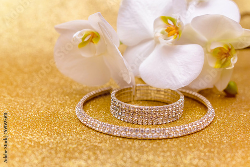 Bracelet and necklace on a gold shiny background
