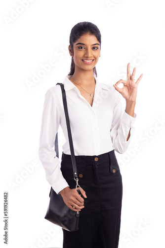 Indian young business woman showing hand sign with hand bag 