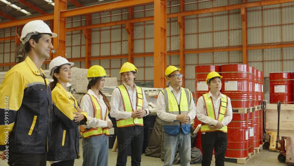 Foreman and group of workers applaud after factory manager is successfully trained.in the morning before starting to work in production plant.Safety first concept,Planning and production procedures. Foreman and group of workers applaud after factory manager is successfully trained.in the morning before starting to work in production plant.Safety first concept,Planning and production procedures.