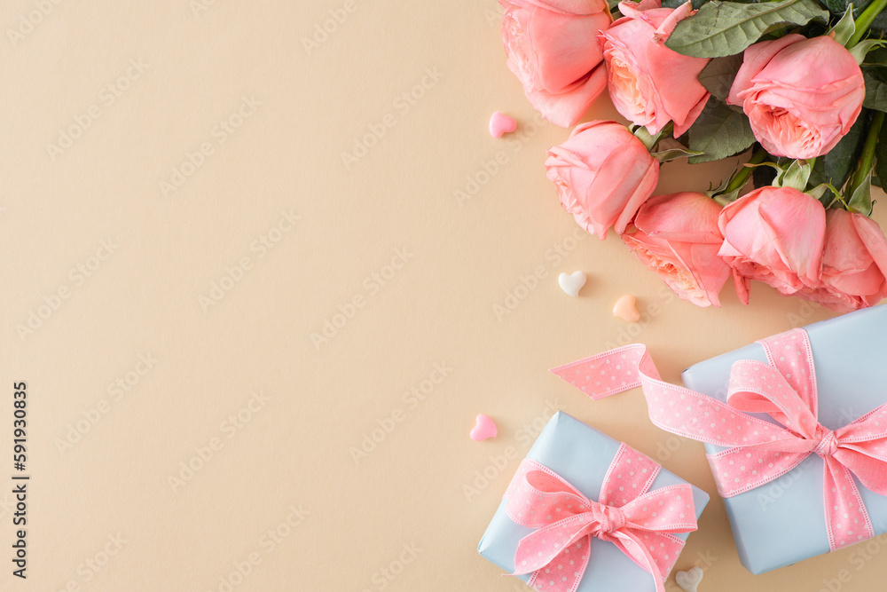 Happy Mother Day idea. Top view composition of present boxes bouquet of pink roses and small hearts on isolated pastel beige background with blank space Happy Mother Day idea. Top view composition of present boxes bouquet of pink roses and small hearts on isolated pastel beige background with blank space