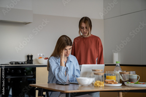 Obraz na plátně Upset depressed young woman single mother living with teen daughter sitting at k