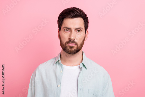 Photo portrait of attractive young man serious face indifferent calm dressed stylish blue clothes isolated on pink color background