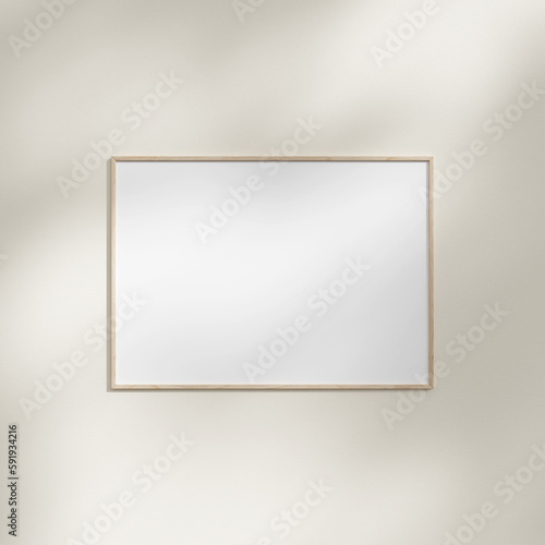 Frame hanging on a white wall mockup with leaf shadow