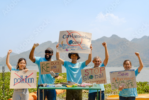 Group of diverse volunteers protest climate change showing the power of unity in charitable environment conservation and social responsibility with banners, key success in making future a better world photo