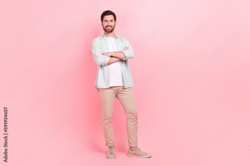 Fototapeta premium Full body photo of handsome young guy folded hands confident pose startup wear trendy blue clothes isolated on pink color background