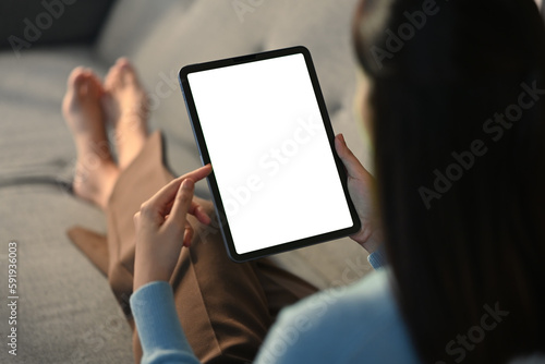 Closeup woman holding empty screen of digital tablet on sofa.