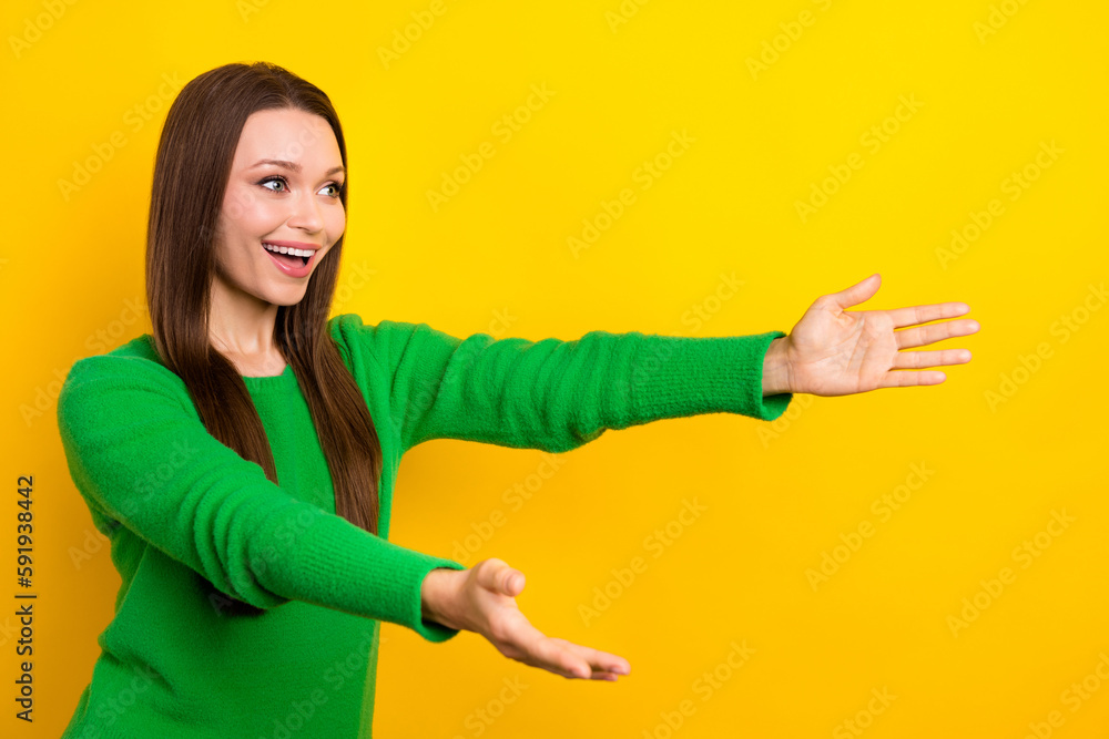 Profile portrait of cheerful nice lady raise opened arms look empty space isolated on yellow color background Profile portrait of cheerful nice lady raise opened arms look empty space isolated on yellow color background