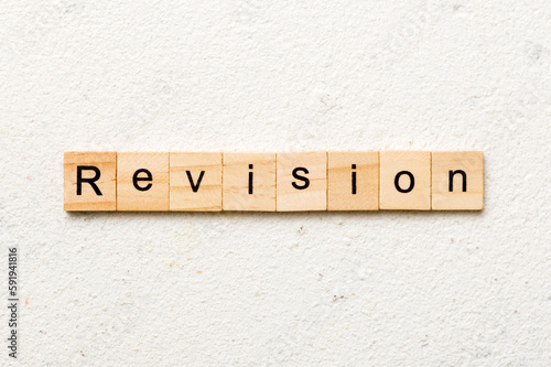 revision word written on wood block. revision text on table, concept