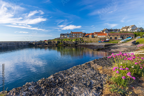 The small fishing village of Craster, with its picturesque harbour, on the coast of Northumberland, England photo