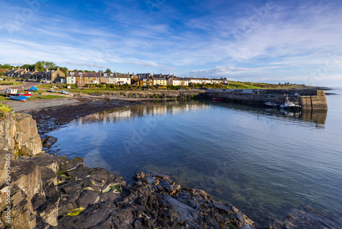 The small fishing village of Craster, with its picturesque harbour, on the coast of Northumberland, England photo