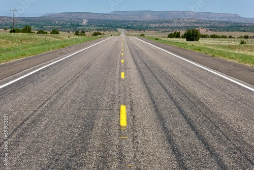 The open road of Route 66 with mountains in the diastance close to Santa Fe, NM, USA. 