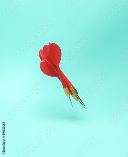 Red darts needles levitating on a blue background