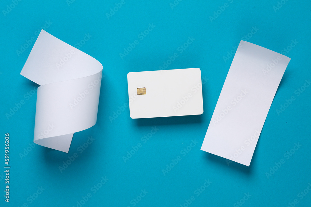 Mockup of white blank bank card with chip and check tapes on blue