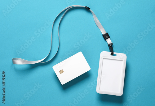 Mockup of white blank bank card with chip and id card with rope on blue background. Template for design