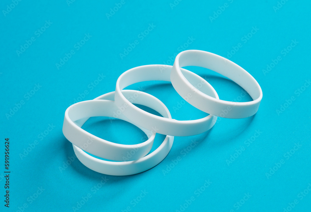 White silicone bracelets on a blue background White silicone bracelets on a blue background