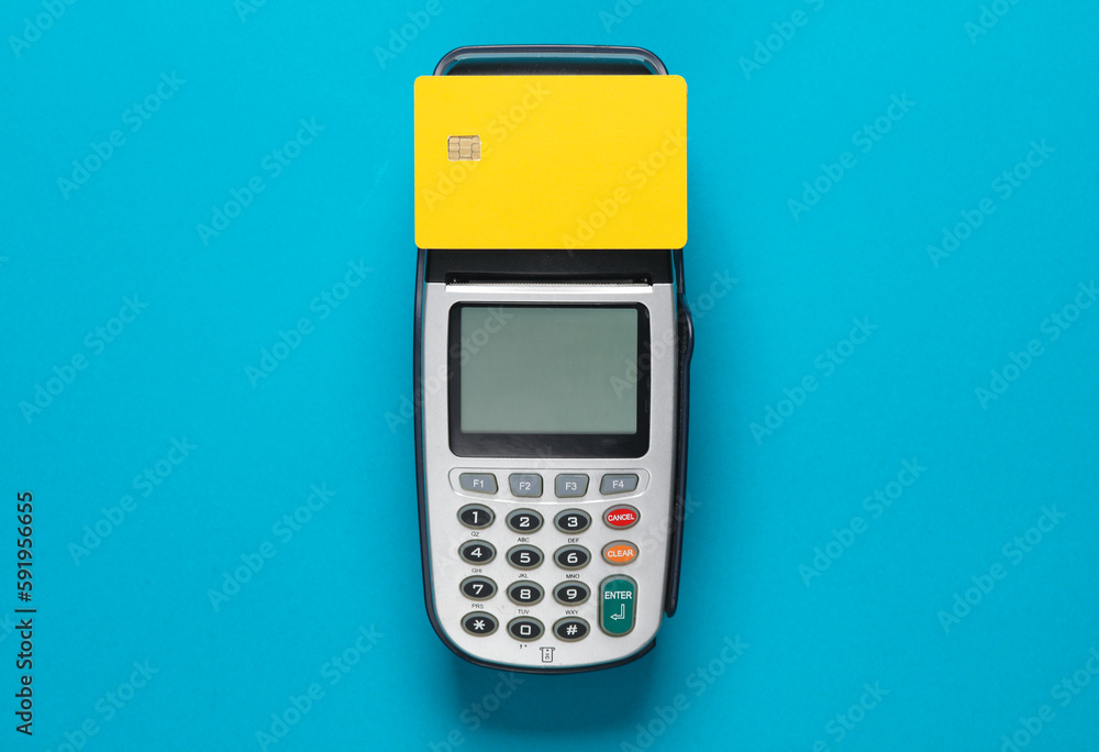 Yellow bank card with chip and pos terminal on a blue background Yellow bank card with chip and pos terminal on a blue background