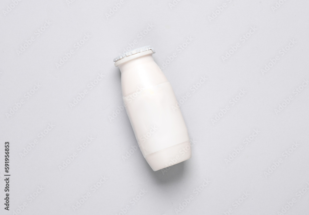 White bottle of yogurt on gray background. Top view White bottle of yogurt on gray background. Top view