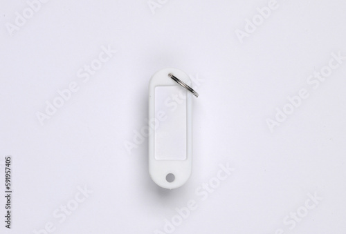 White keychain or key tag on a gray background. Template for design, mockup