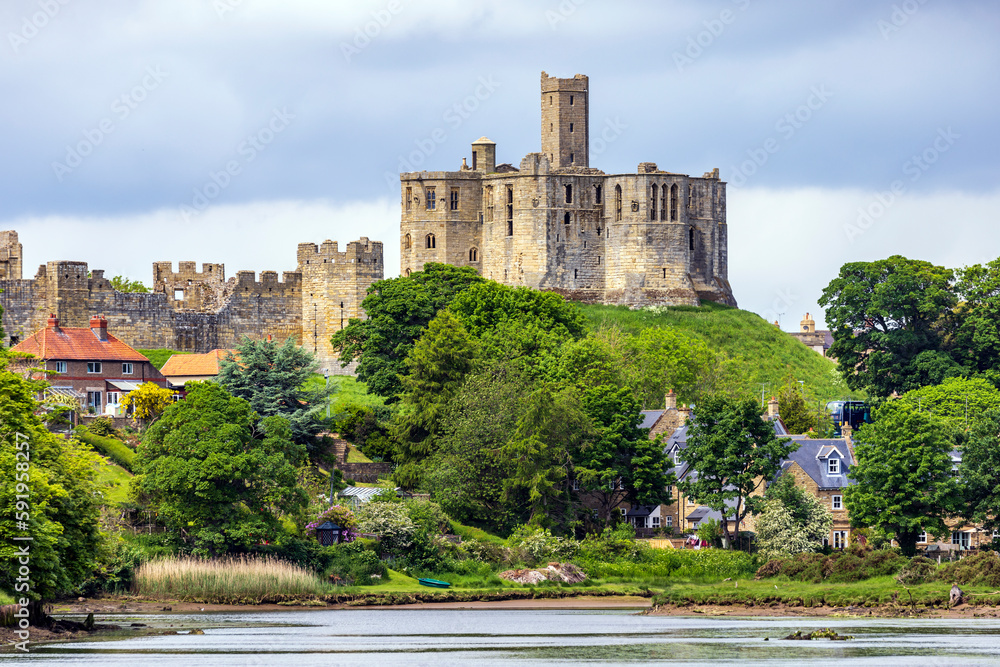 View over the river Coquet to the medieval Warkworth Castle and the village of Warkworth in Northumberland, England.