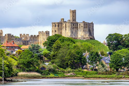 View over the river Coquet to the medieval Warkworth Castle and the village of Warkworth in Northumberland, England. photo
