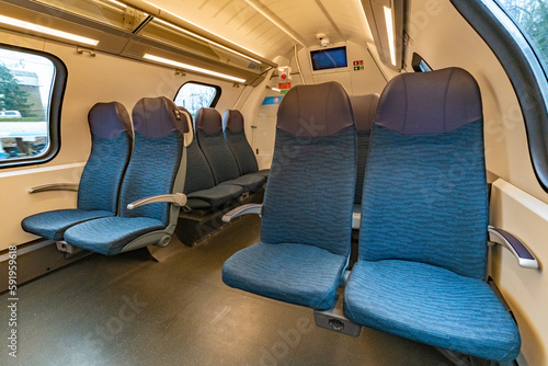 Interior of modern electric train in Slovenia with blue comfortable seats