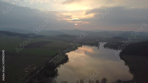 Picturesque aerial photography of rural land and lake in the evening. Top view drone shot. Agricultural area of czech republic, Europe. Spectacular photo wallpaper. Discover the beauty of earth.