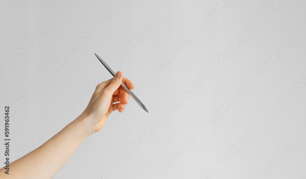 hand holding a pen on the white background hand holding a pen on the white background