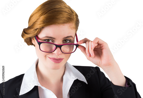 Redhead businesswoman touching her glasses