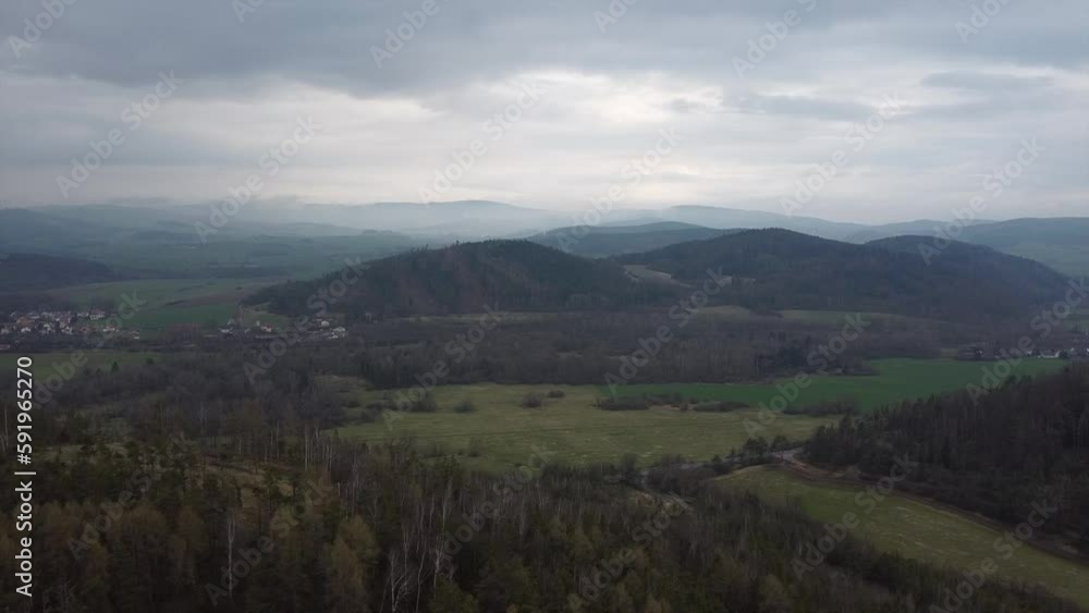 Aerial shot of scenic wild nature. Forests, fields, meadows. mountains in the distance in a haze Aerial shot of scenic wild nature. Forests, fields, meadows. mountains in the distance in a haze