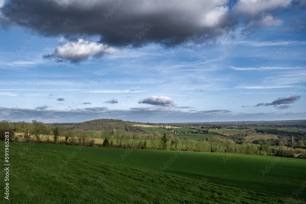 View of the countryside in France. Sky with clouds. Spacious volumetric view of the green meadows. View of the countryside in France. Sky with clouds. Spacious volumetric view of the green meadows.
