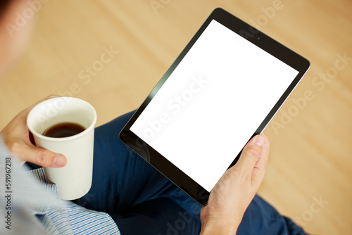 Vertical tablet mockup for advertising. Mock up tablet on businessman hand holding and using with blank white screen copy space for text advertisement.