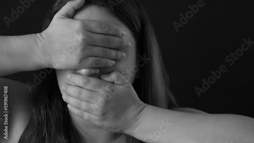Black and white portrait of shocked upset sad middle-aged woman with long hair covering mouth, eyes with hands, refusing to see, hear. Unexpectedness, keeping secret, emotions, gesturing, silence.