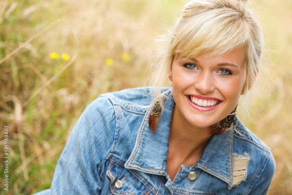 Portrait Of A Woman Sitting In A Field Of Tall Grass; Oregon, United States Of America Portrait Of A Woman Sitting In A Field Of Tall Grass; Oregon, United States Of America