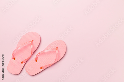 Bright flip flops on color background, top view © Liami