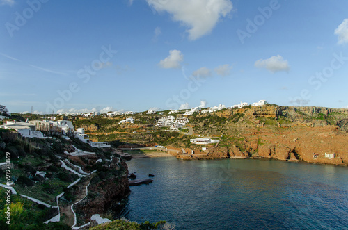 Cala Morell, una cala urbana de la zona norte de Menorca que está muy bien protegida por su forma y por los acantilados que la rodean. photo