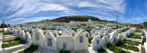 Fes, Morocco, Africa: daily life on a sunny day with the amazing panoramic view of a muslim cemetery built on the ancient walls of the city with tombstones, graves and inscriptions